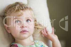 Adorable Blonde Haired and Blue Eyed Little Girl in Chair