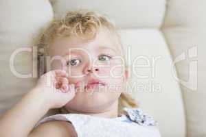 Adorable Blonde Haired and Blue Eyed Little Girl in Chair