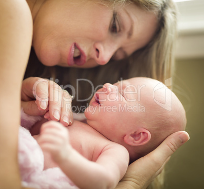 Young Beautiful Mother Holding Her Precious Newborn Baby Girl