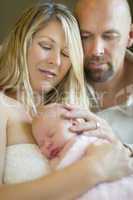 Beautiful Young Couple Holding Their Newborn Baby Girl