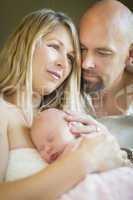 Beautiful Young Couple Holding Their Newborn Baby Girl