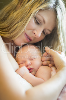 Young Beautiful Mother Holding Her Precious Newborn Baby Girl