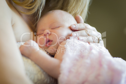 Hands of Mother Holding Her Newborn Baby Girl