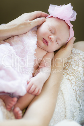 Hands of Mother Holding Her Newborn Baby Girl