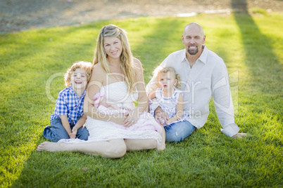 Beautiful Young Family Portrait Outside on Grass