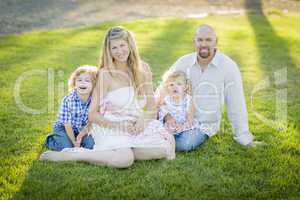 Beautiful Young Family Portrait Outside on Grass