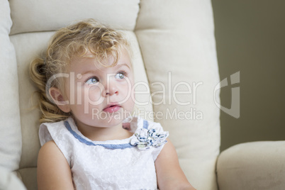 Adorable Blonde Haired and Blue Eyed Little Girl in Chair