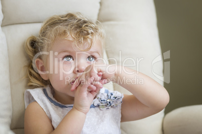 Adorable Blonde Haired and Blue Eyed Little Girl in Chair