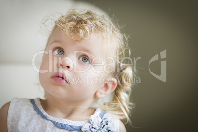 Adorable Blonde Haired and Blue Eyed Little Girl in Chair