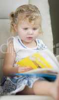 Blonde Haired Blue Eyed Little Girl Reading Her Book