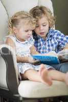 Young Brother and Sister Reading a Book Together
