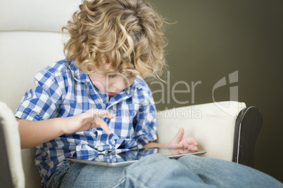 Young Blond Boy Using His Computer Tablet