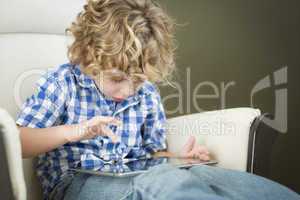 Young Blond Boy Using His Computer Tablet