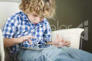 Young Blond Boy Using His Computer Tablet