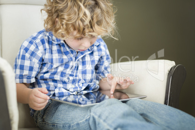 Young Blond Boy Using His Computer Tablet