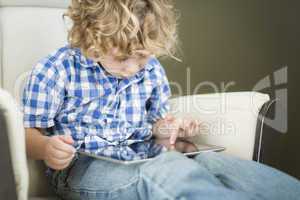 Young Blond Boy Using His Computer Tablet