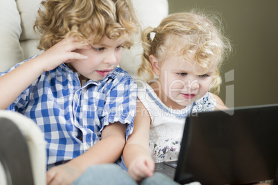 Young Brother and Sister Using Their Computer Laptop Together