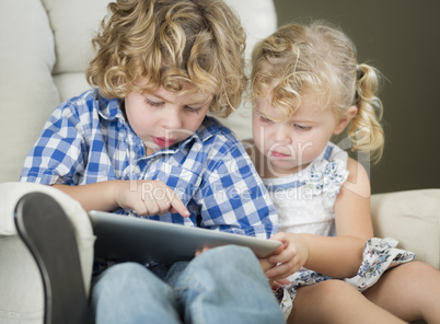 Young Brother and Sister Using Their Computer Tablet Together