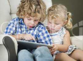 Young Brother and Sister Using Their Computer Tablet Together