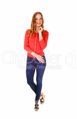 Blond girl in jeans standing.