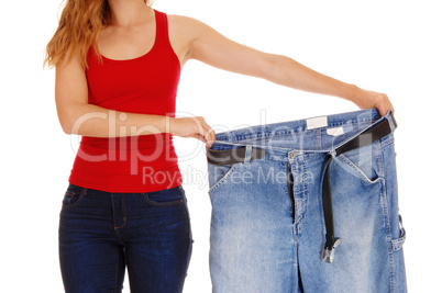 Woman holding big pants.