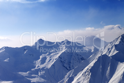 Snowy mountains in early morning fog