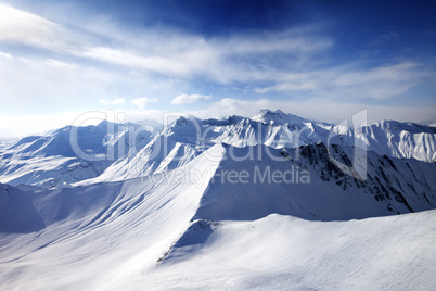 Off-piste slope and sunlight sky