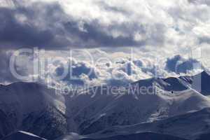 Evening sunlight mountain and silhouette of parachutist