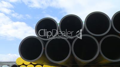 Pipes stacked in construction site dolly shot