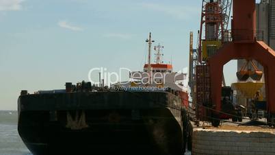 Cargo ship moving load at port Time lapse