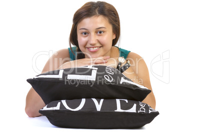 Teenage girl laying over pillows