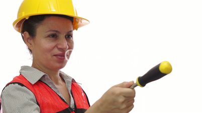 Smiling Female Worker Passing a Screwdriver