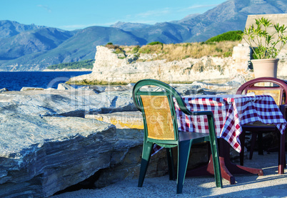 Restaurant tables over beautiful ocean at dusk