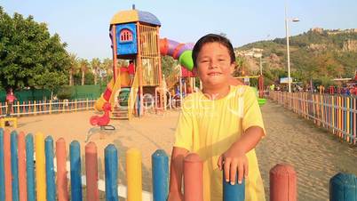 child smiling and running to playground