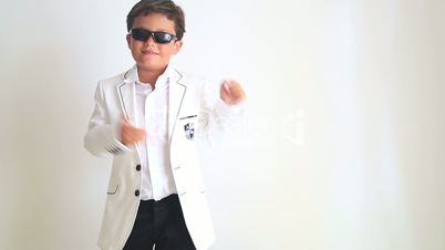 Fashionable boy with sun glasses turn around and pointing