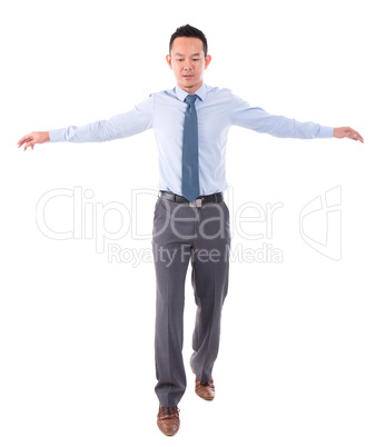 Asian business man walking balance