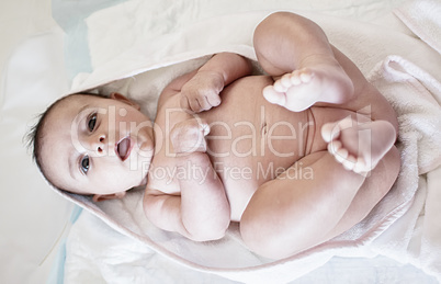 Newborn baby with happy face laying and playing