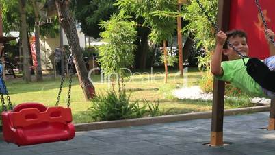 boy on playground swing