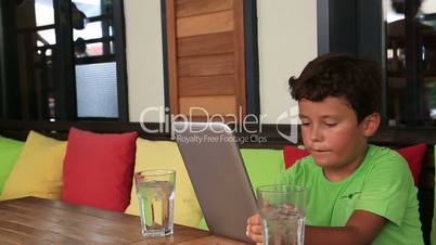 Mother and son with digital tablet at cafe