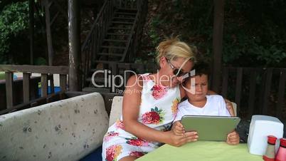 mother and son using digital tablet
