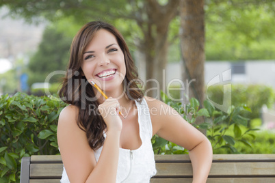 Young Adult Female Student on Bench Outdoors