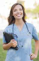 Young Adult Woman Doctor or Nurse Holding Touch Pad Outside