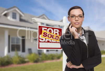 Mixed Race Woman in Front of House and Sold Sign