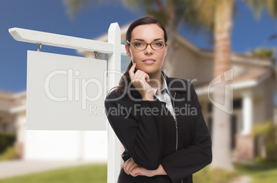 Woman In Front Of House and Blank Real Estate Sign