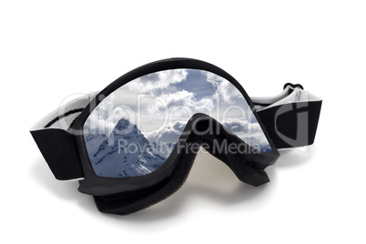 Ski goggles with reflection of snow mountains