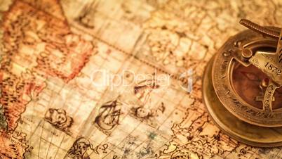 Vintage still life. Vintage magnifying glass lies and compass on ancient world map in 1565.