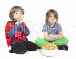 two boys with peanut puffs
