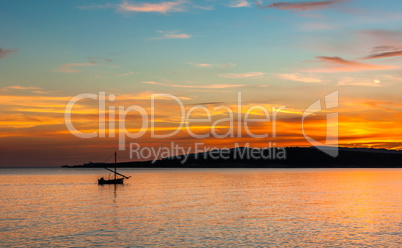 fishing boat on the coast at sunset