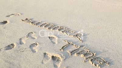 Summer time written on sand