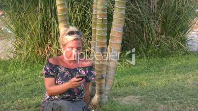 Woman using smart phone in nature
